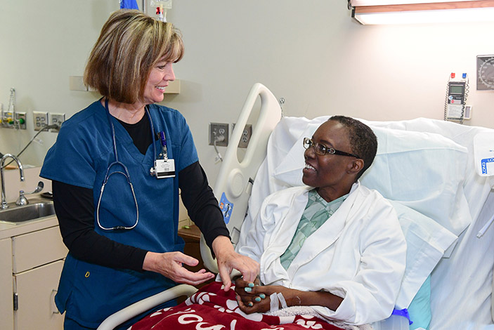  Wendy Delaserna, McCollum¿s primary nurse during her stay at Emory, prepares her for the move to the new hospital tower.